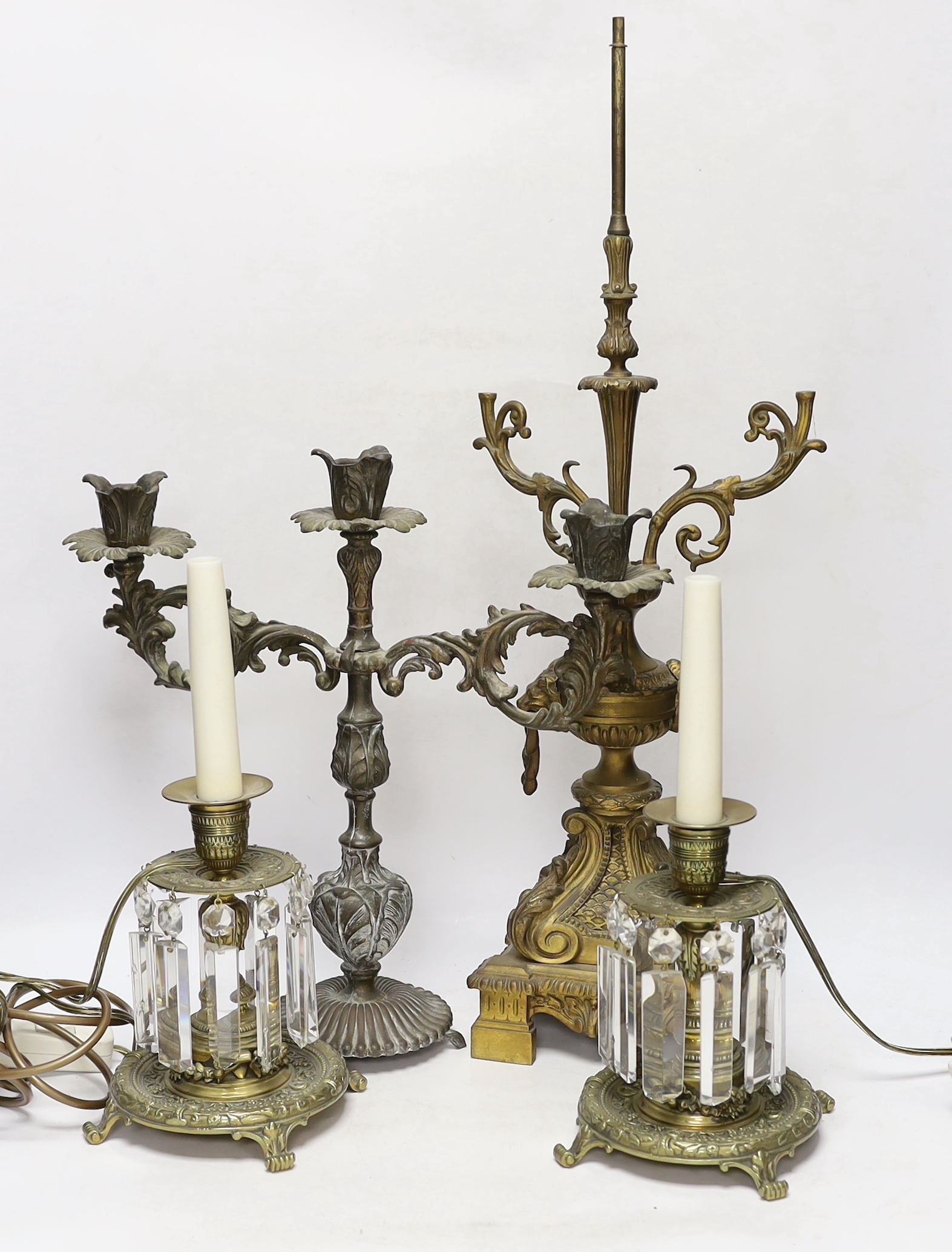 A pair of brass lustre drop candlesticks, lamp base and three branch candelabra, 59cm high